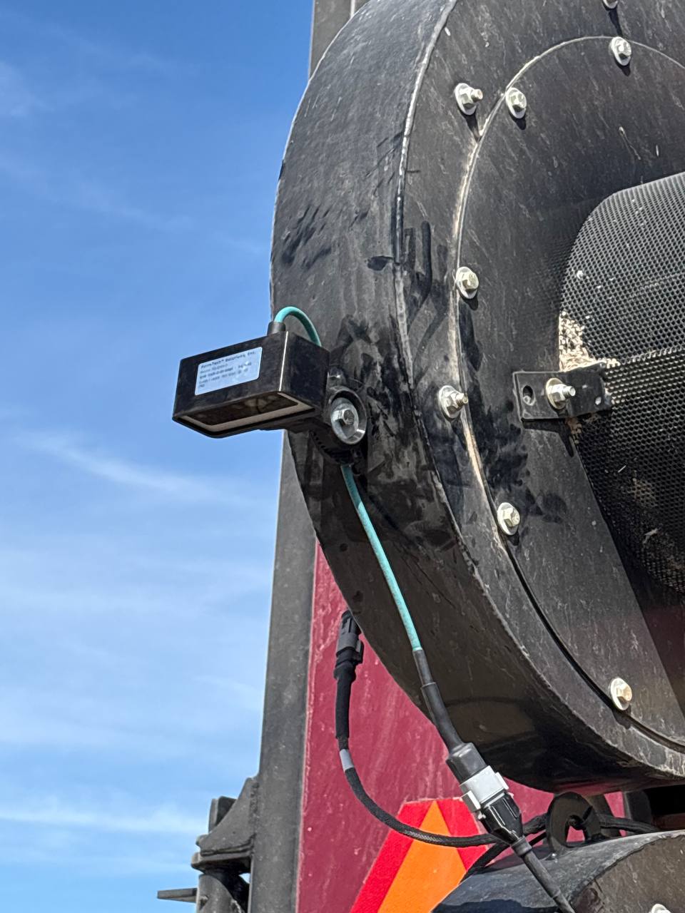 FarmDefender rock detection — field with rocks visible, mounted depth camera unit scanning ahead